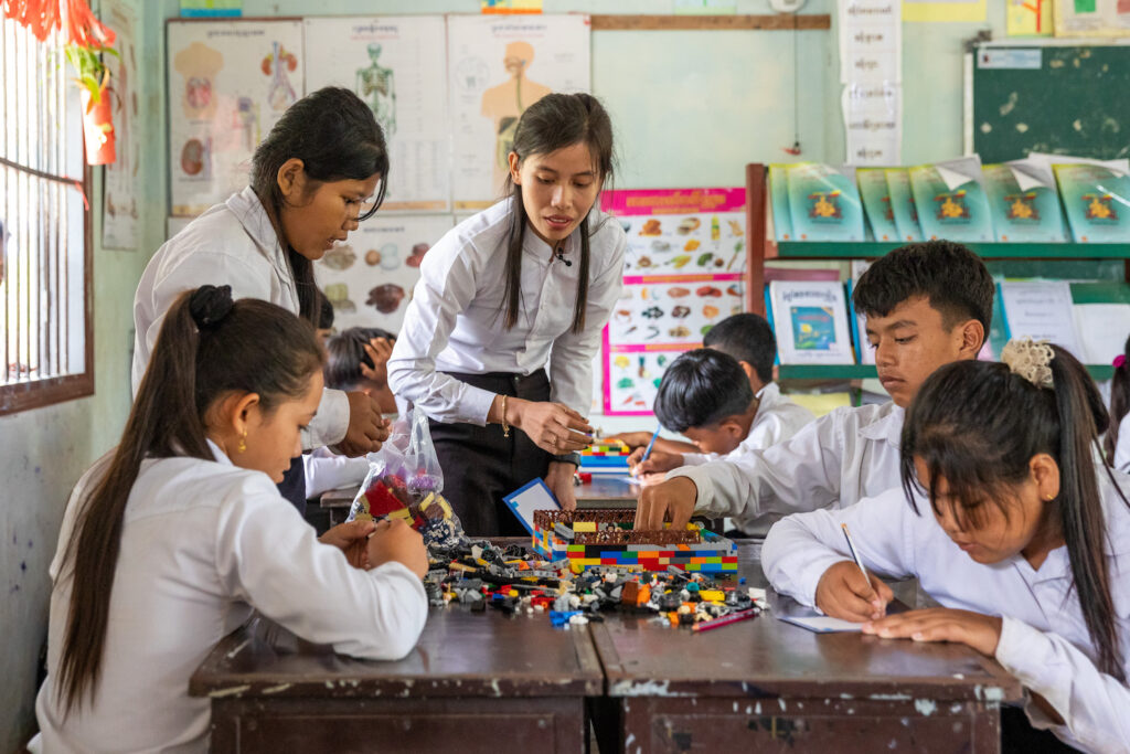 Teacher Kong Kunthea, 29, working with children and their lego at school