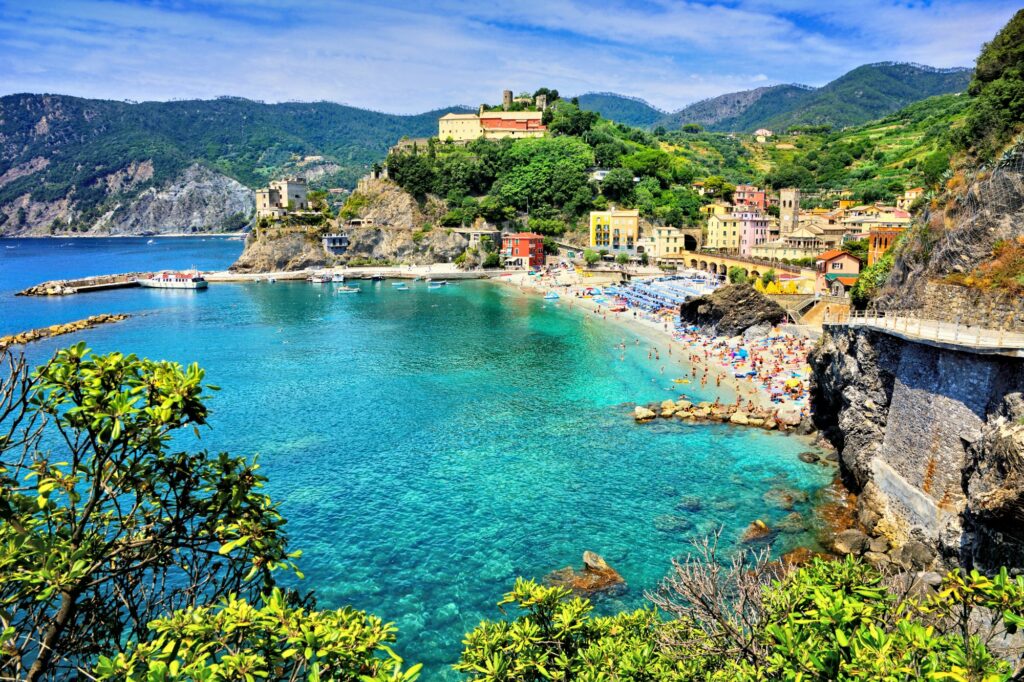 A turquoise bay at the base of a historic town on the coast of Italy — Monaco Formula 1