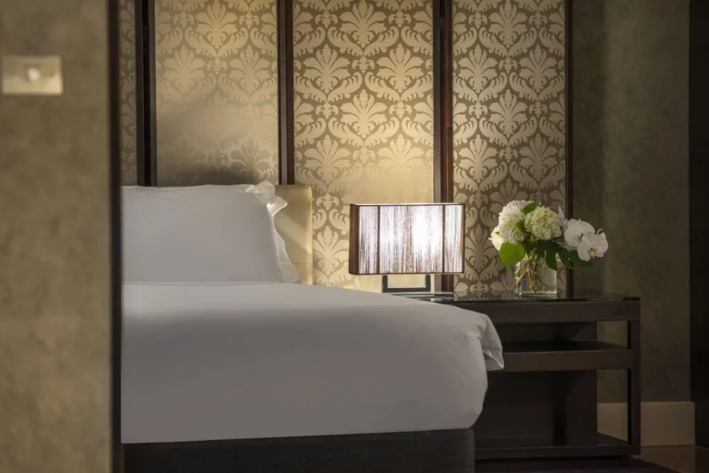 A sneak peek of the bed, surrounded by opulent wallpaper, at Intercontinental Melbourne.